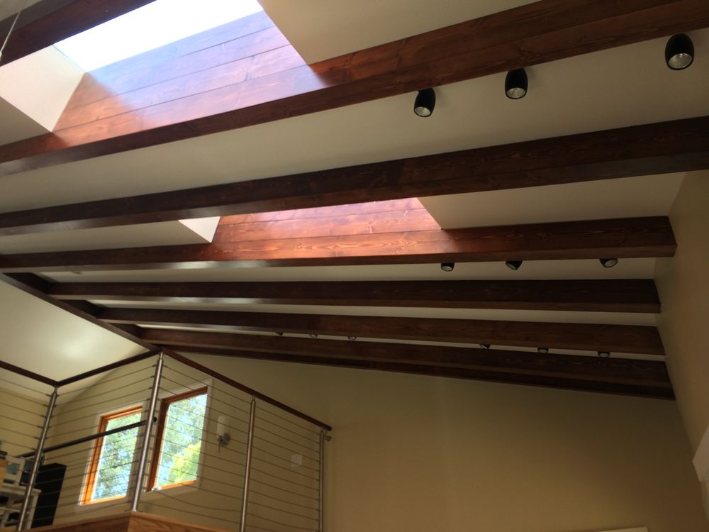 Detail of exposed structural timber beams and skylight wells